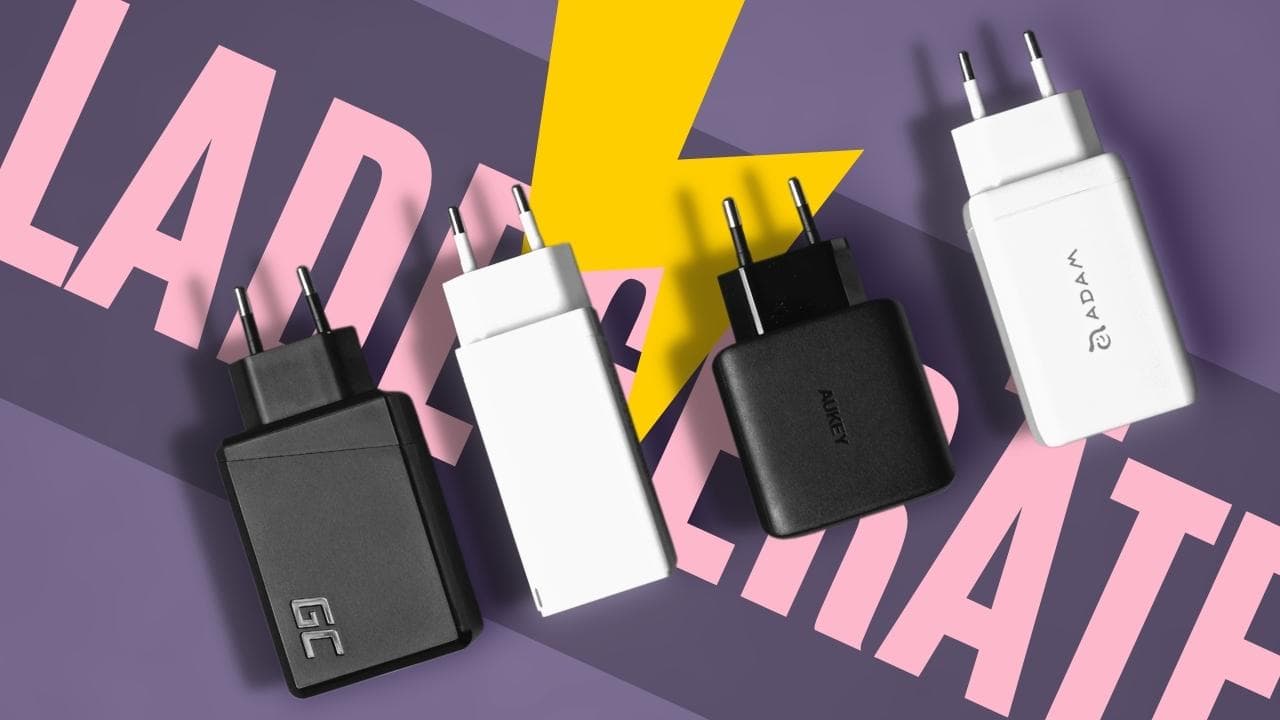 Multiple iPhone chargers in black and white on a purple background