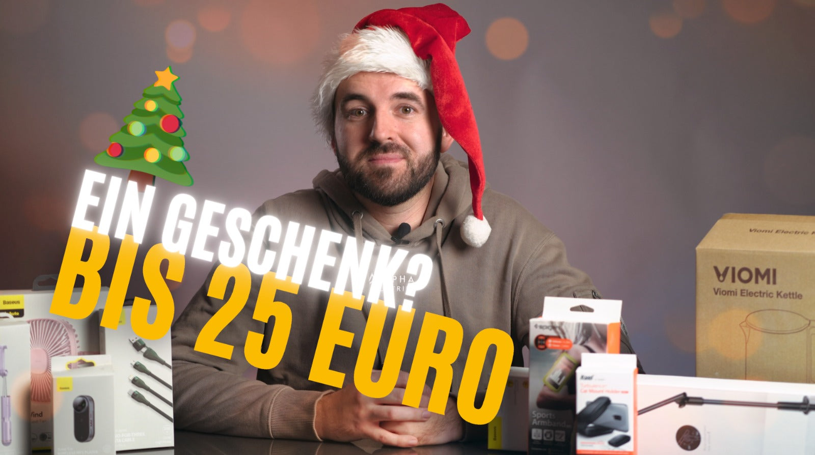 Man in Santa hat with gifts under 25 Euros, featuring brands like Viomi and Spigen, with Christmas theme.