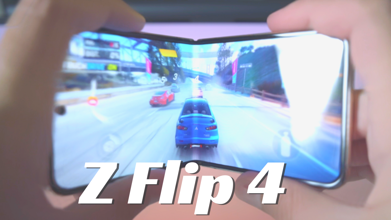 Hands holding the Samsung Z Flip 4 smartphone while playing a racing game, showcasing its foldable screen feature.