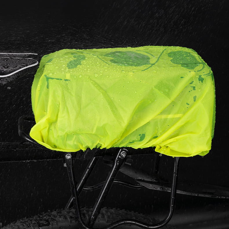 Neon yellow rain cover on Vayox VA0166 bike pannier, mounted on black rear bike rack for weather protection.