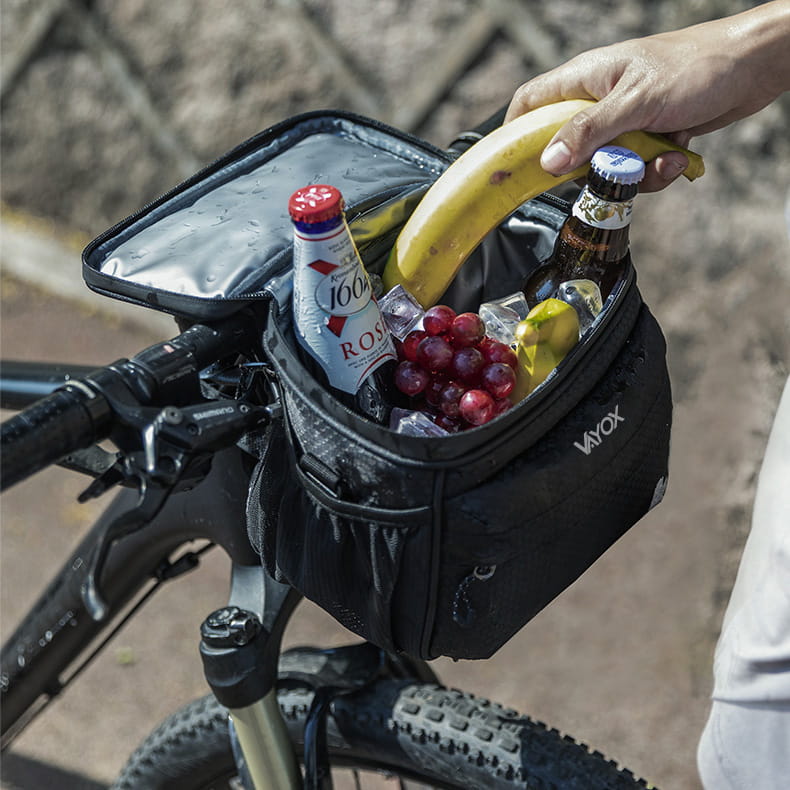 Vayox VA0167 black insulated bike handlebar bag holding drinks and snacks, including bananas and beverages.