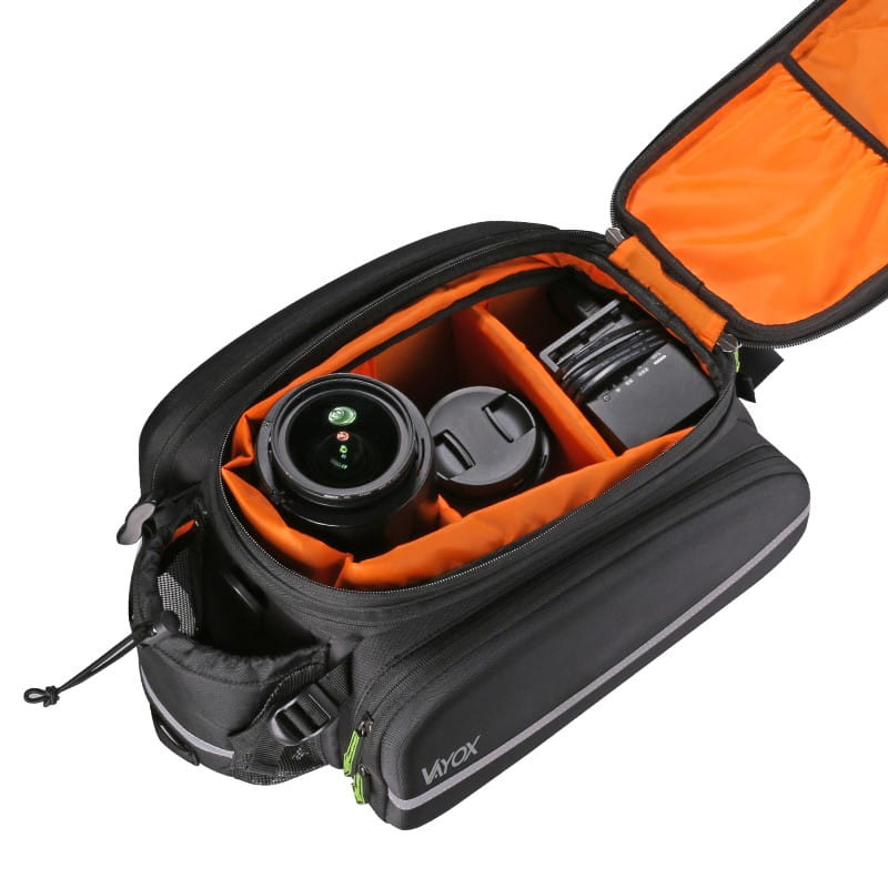 Open Vayox VA0346 35L bike pannier with orange interior, showcasing storage for camera gear. Ideal for cycling tours and shopping.