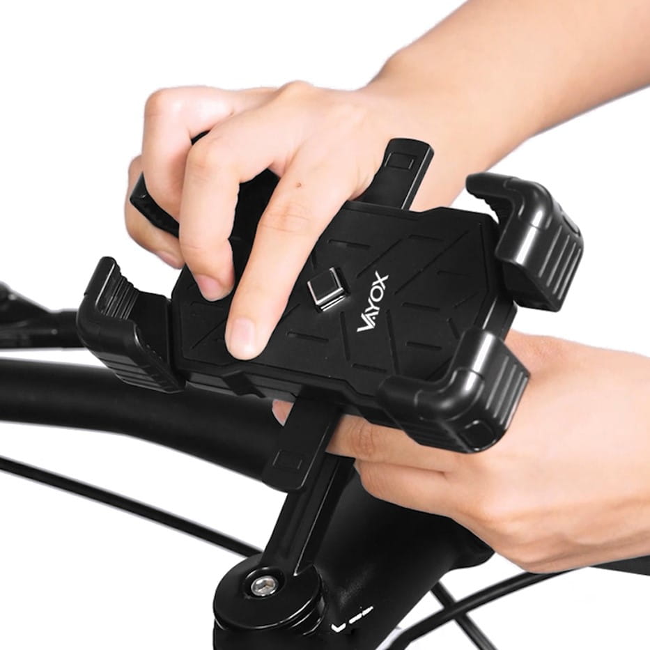 Person installing Vayox VA0344 black phone holder on bicycle handlebar, suitable for 4.5"-7.2" smartphones, sturdy and universal fit