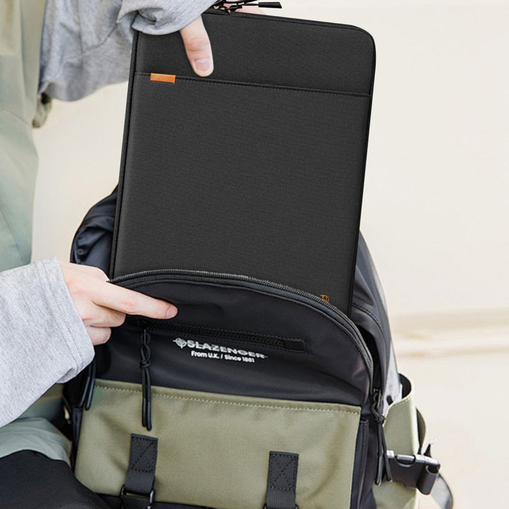 Person taking a black Tech-Protect laptop sleeve out of a backpack, demonstrating its portability.