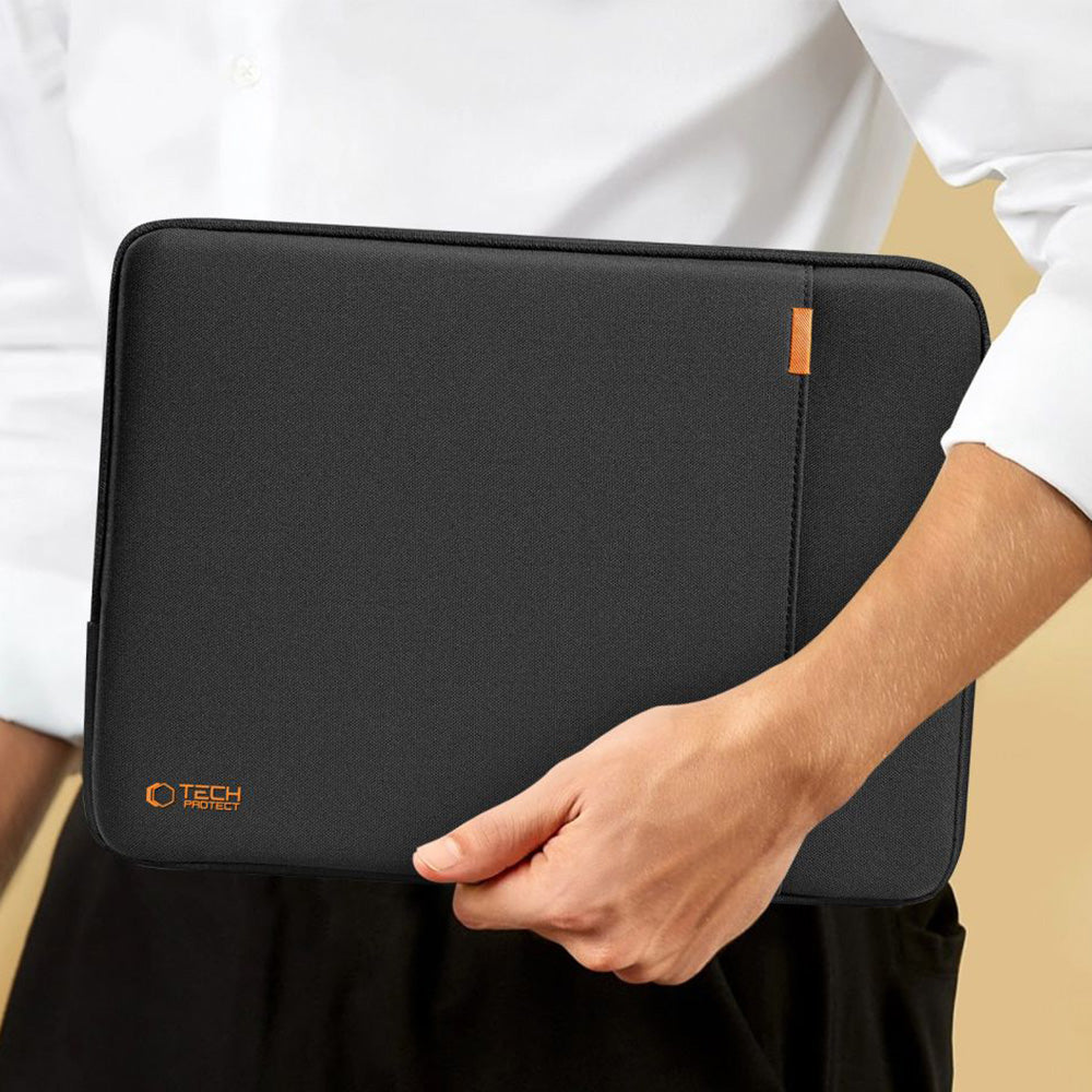 Tech-Protect Defender laptop sleeve in black, held by a person, designed for 13-14 inch laptops.